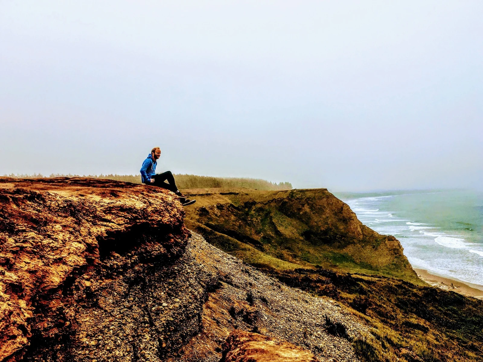 Dylan sitting above the Pacific Ocean